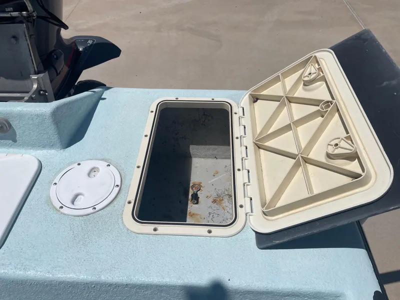 Slide: The Image of Open storage compartment on a 2006 Explorer 19 boat, showing interior details. - 9