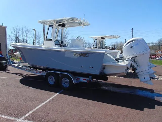 The Image of 2025 Parker 2600 CC boat on trailer, featuring dual outboard engines. - 1