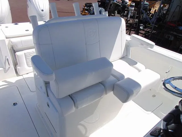 Slide: The Image of 2025 Parker 2600 CC boat with white cushioned seating and armrests. - 14