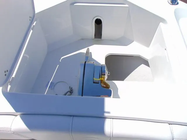 Slide: The Image of 2025 Parker 2600 CC boat anchor compartment with winch, featuring sleek white interior design. - 17