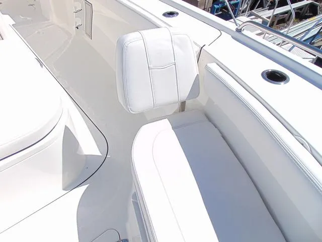 Slide: The Image of 2025 Parker 2600 CC boat interior with white seating and cup holders. - 19