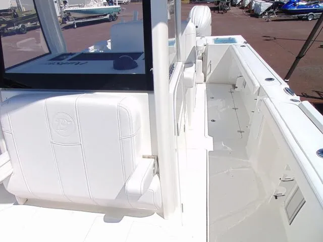 Slide: The Image of 2025 Parker 2600 CC boat interior with white seating and spacious deck. - 20