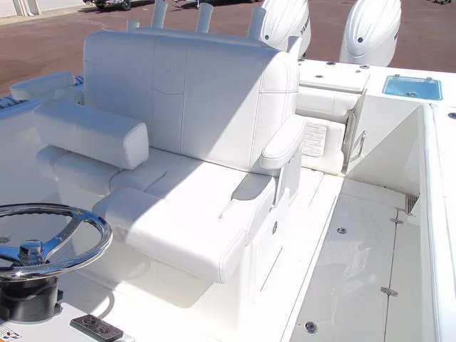 Slide: The Image of 2025 Parker 2600 CC boat interior with white seating and steering wheel. - 22