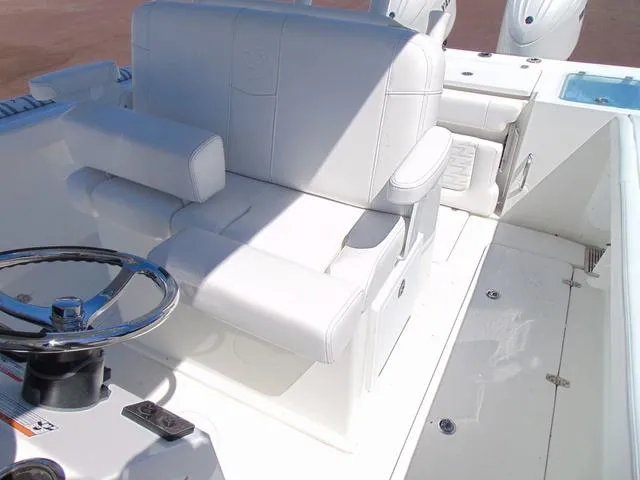 Slide: The Image of 2025 Parker 2600 CC boat interior with white seating and steering wheel. - 23