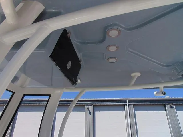 Slide: The Image of 2025 Parker 2600 CC boat interior roof with built-in lights and storage compartment. - 25