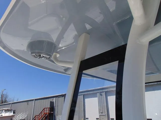 Slide: The Image of 2025 Parker 2600 CC boat with sleek design and modern features, docked near industrial building. - 27