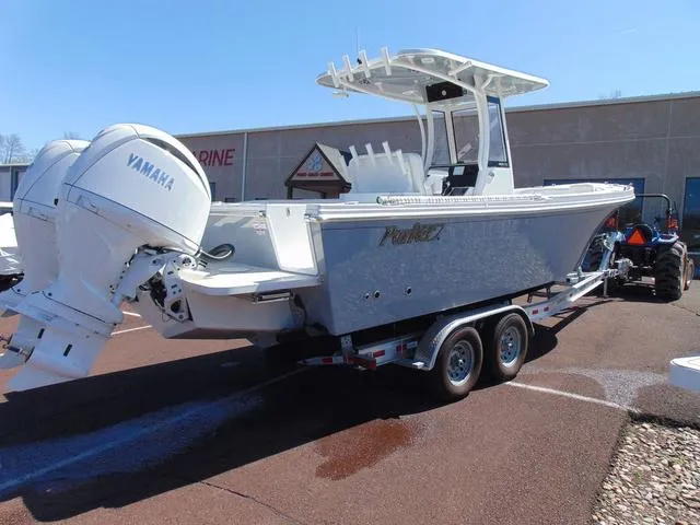 Slide: The Image of 2025 Parker 2600 CC boat with Yamaha engines on a trailer in a parking lot. - 4