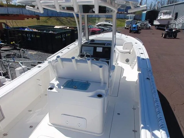 Slide: The Image of 2025 Parker 2600 CC boat with center console and seating, docked outdoors. - 6