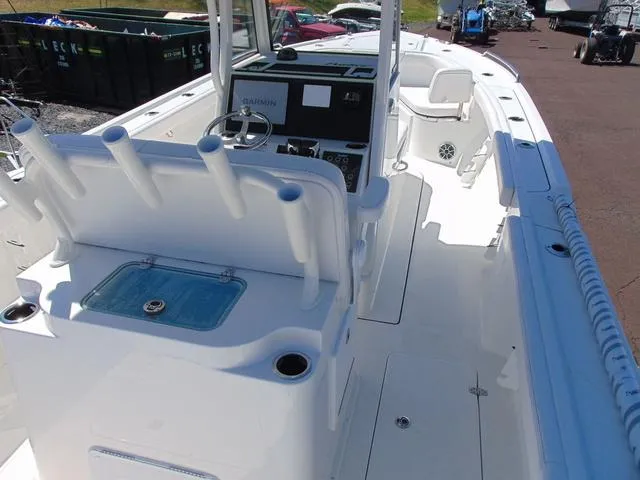 Slide: The Image of 2025 Parker 2600 CC boat interior with rod holders and control panel. - 7