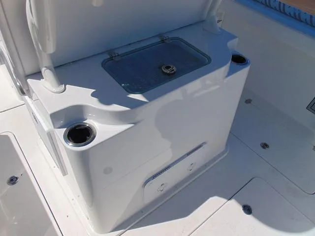 Slide: The Image of 2025 Parker 2600 CC boat interior with storage compartment and cup holders. - 9
