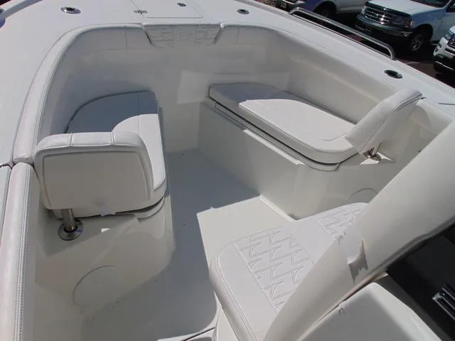 Slide: The Image of 2025 Parker 2200 CC boat interior with white seating and spacious layout. - 10