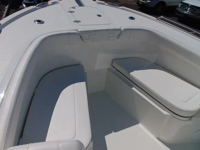 Slide: The Image of 2025 Parker 2200 CC boat interior with white cushioned seating. - 11