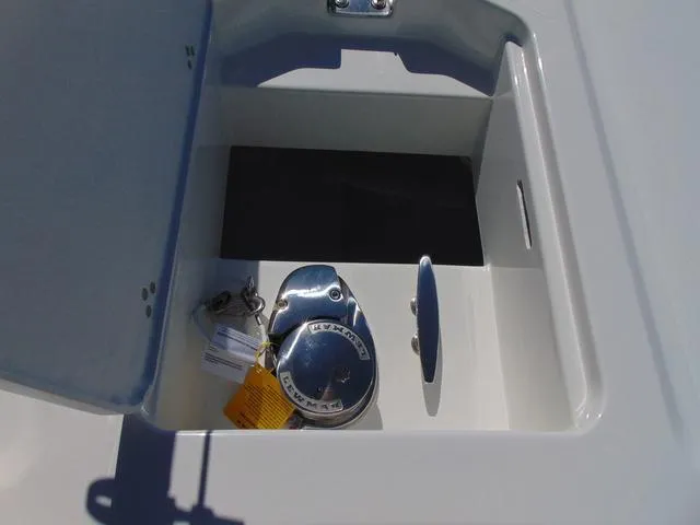 Slide: The Image of 2025 Parker 2200 CC boat compartment with keys and equipment inside. - 12