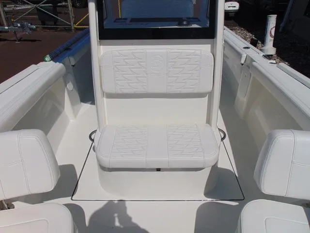 Slide: The Image of 2025 Parker 2200 CC boat interior with white cushioned seating. - 13