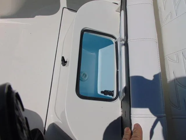 Slide: The Image of Open storage compartment on a 2025 Parker 2200 CC boat, featuring a sleek white design. - 17