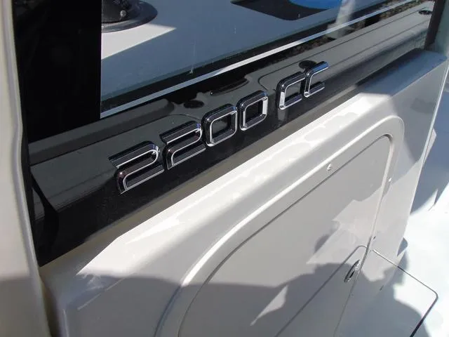 Slide: The Image of 2025 Parker 2200 CC boat model emblem on a sleek white surface. - 18