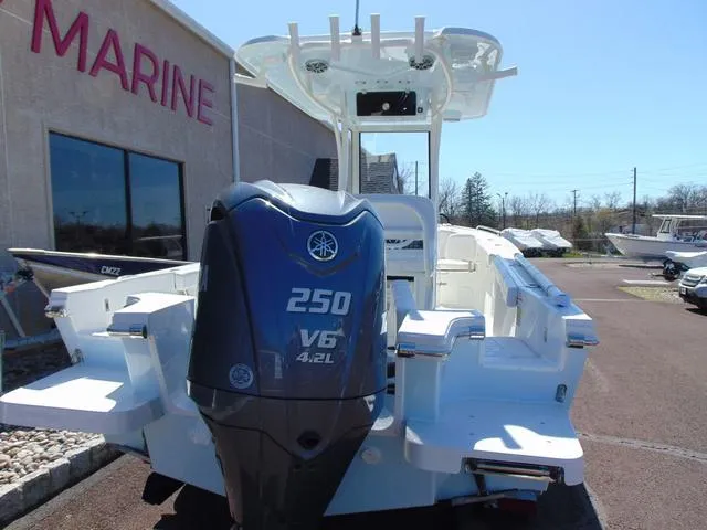 Slide: The Image of 2025 Parker 2200 CC boat with Yamaha 250 V6 engine at a marine dealership. - 4