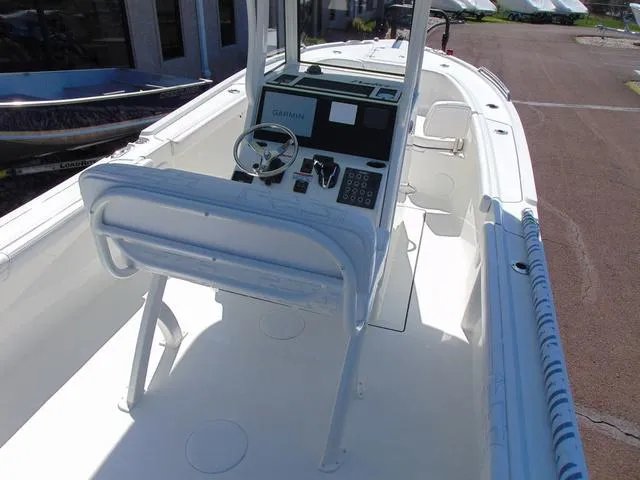 Slide: The Image of 2025 Parker 2200 CC boat interior with steering console and seating. - 5
