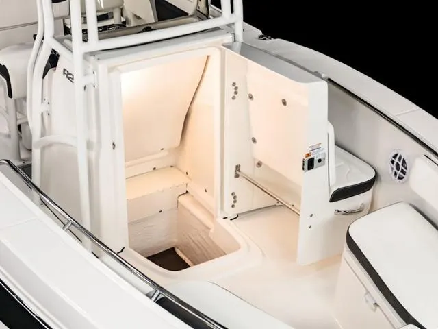Slide: The Image of 2024 Robalo R200 boat interior storage compartment with open door, showcasing spacious design. - 27