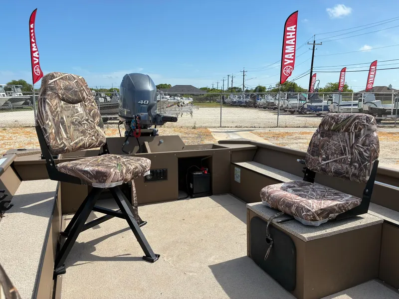 Slide: The Image of 2019 Smoker Craft 1660 SPORTSMAN boat interior with camo seats and Yamaha motor. - 11