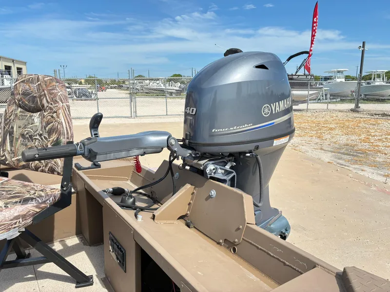 Slide: The Image of 2019 Smoker Craft 1660 SPORTSMAN boat with Yamaha 40HP outboard motor, camo seat, outdoor setting. - 13