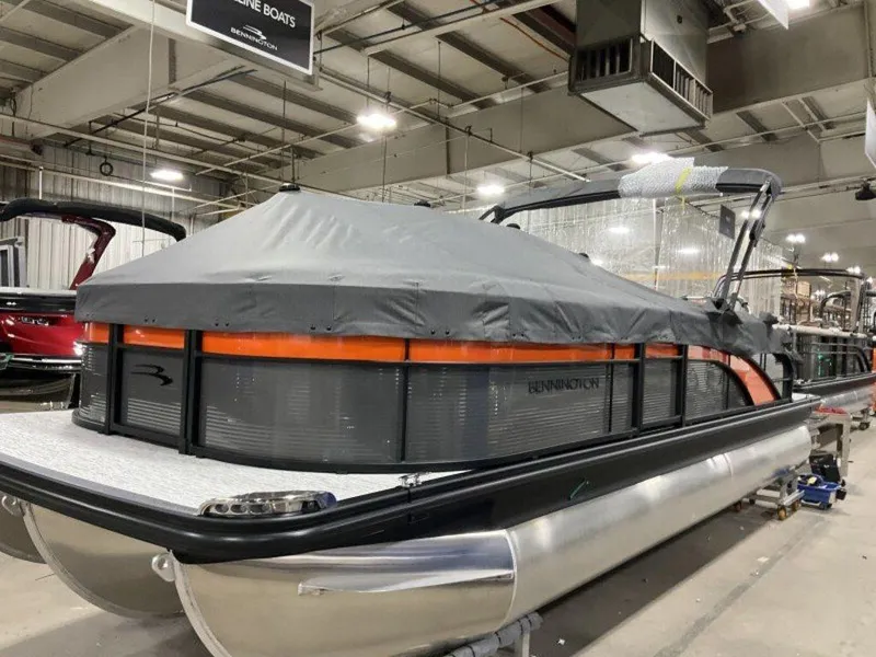 Slide: The Image of 2025 Bennington SX Swingback 22 SXSB pontoon boat with cover in a showroom. - 15