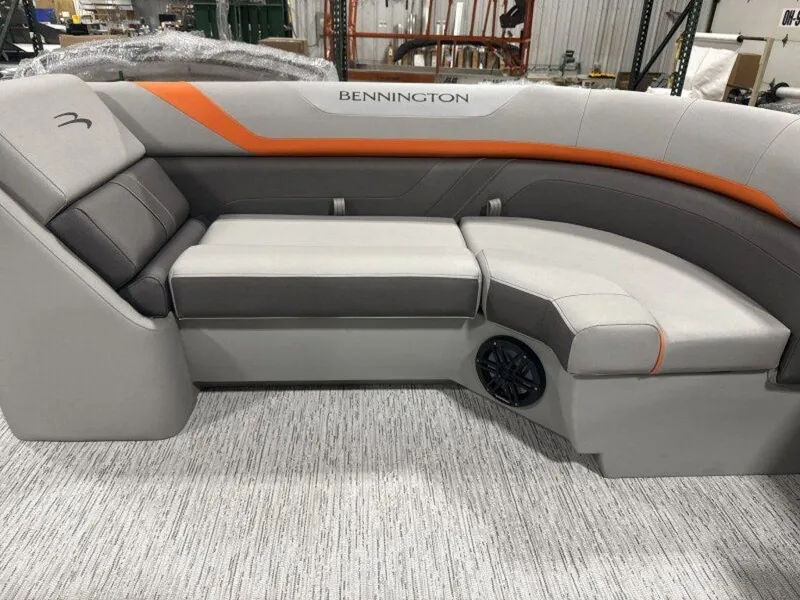 Slide: The Image of 2025 Bennington SX Swingback 22 SXSB boat seating with gray and orange upholstery. - 21