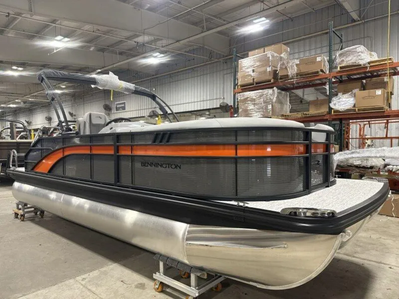 Slide: The Image of 2025 Bennington SX Swingback 22 SXSB pontoon boat in a warehouse setting. - 22