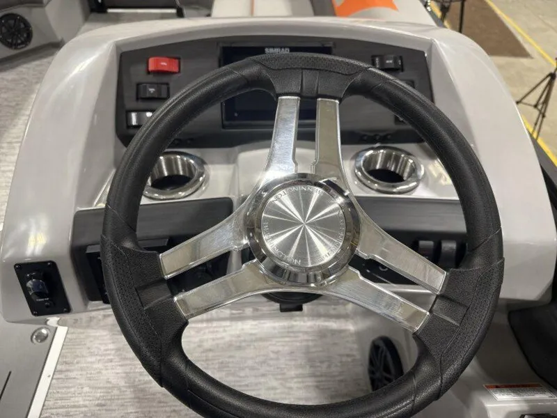 Slide: The Image of Steering wheel of 2025 Bennington SX Swingback 22 SXSB boat, featuring modern dashboard controls. - 5