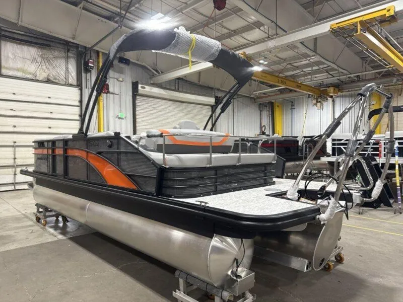Slide: The Image of 2025 Bennington SX Swingback 22 SXSB pontoon boat in a warehouse setting. - 6