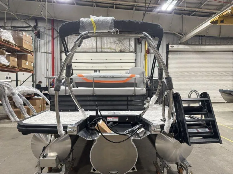 Slide: The Image of 2025 Bennington SX Swingback 22 SXSB pontoon boat in a warehouse setting. - 8