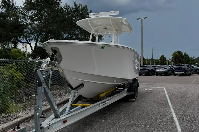 Slide: The Image of 2019 Jupiter 30 HFS boat on trailer in parking lot, overcast sky. - 1