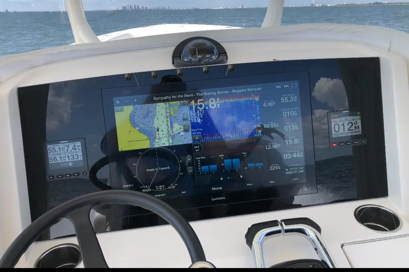 Slide: The Image of Dashboard of a 2019 Jupiter 30 HFS boat with navigation display. - 2