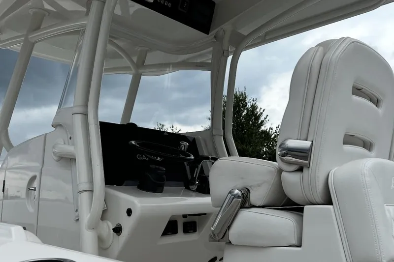 Slide: The Image of 2019 Jupiter 30 HFS boat interior with white seating and control panel. - 4