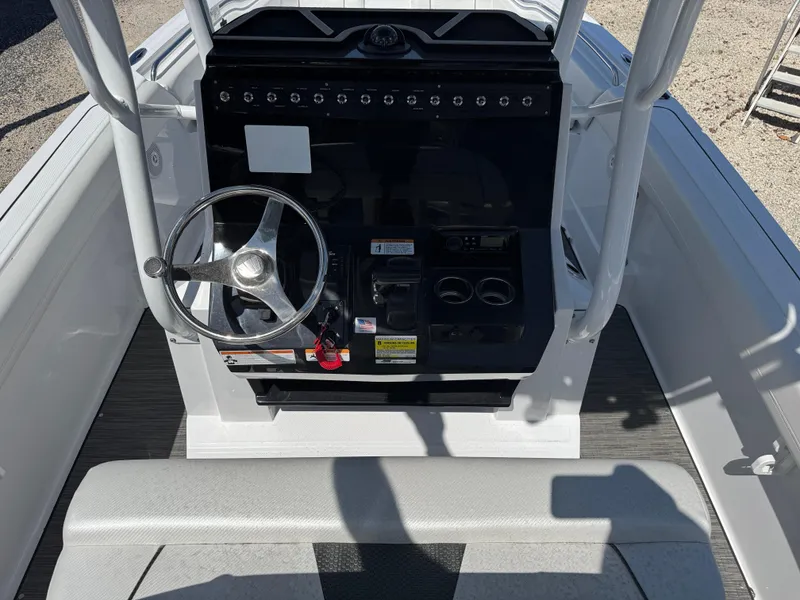 Slide: The Image of 2025 Wellcraft 222 Fisherman boat console with steering wheel and controls. - 11