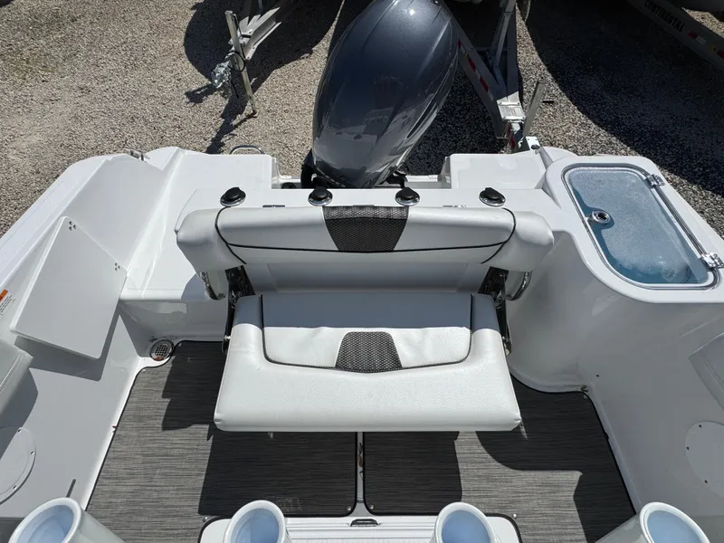 Slide: The Image of 2025 Wellcraft 222 Fisherman boat interior with seating and motor, showcasing modern design. - 13