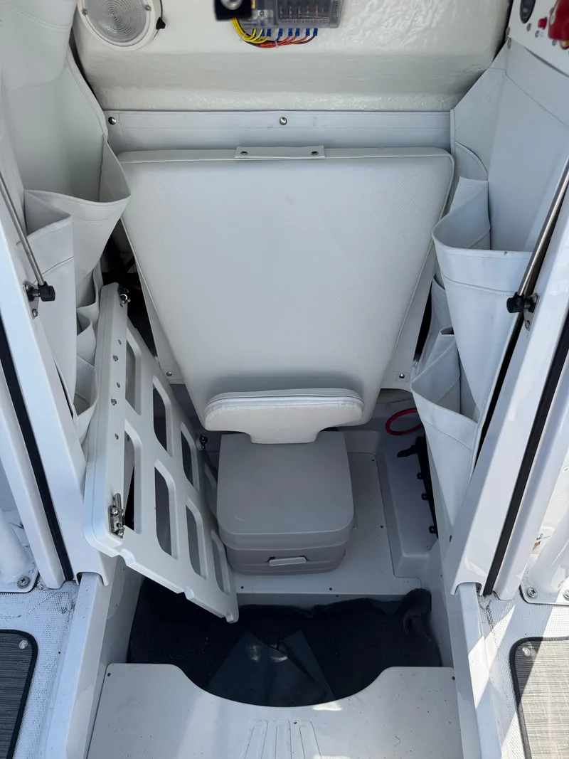 Slide: The Image of 2025 Wellcraft 222 Fisherman boat interior with storage compartments and seating. - 23