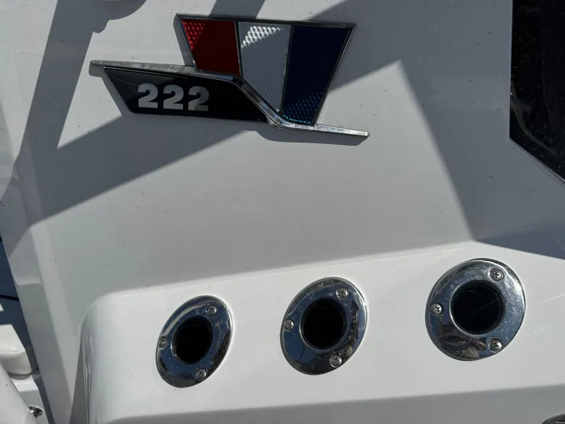 Slide: The Image of 2025 Wellcraft 222 Fisherman boat emblem and chrome fittings on white surface. - 24