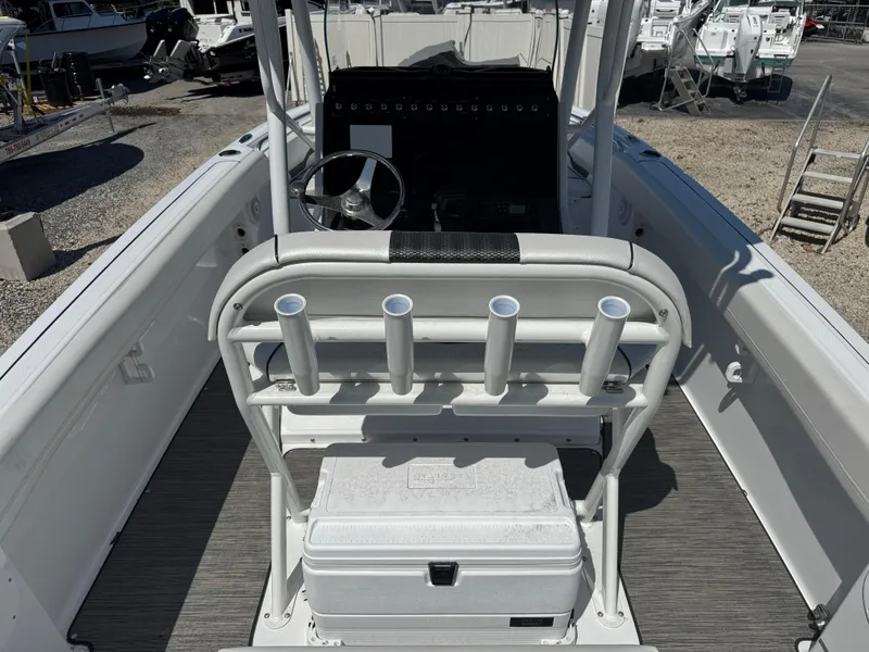 Slide: The Image of 2025 Wellcraft 222 Fisherman boat interior with rod holders and steering console. - 9