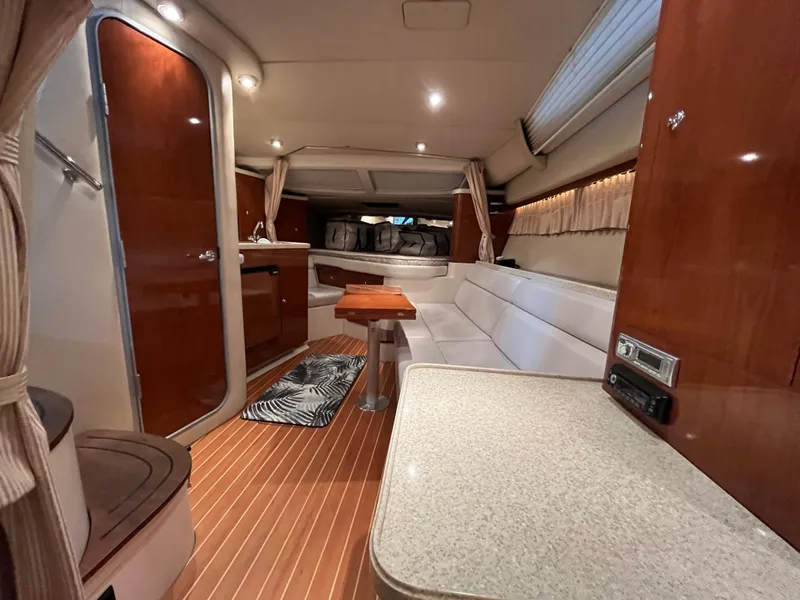 Slide: The Image of Interior of 2006 Regal 3360 Window Express yacht with wood accents and seating area. - 11