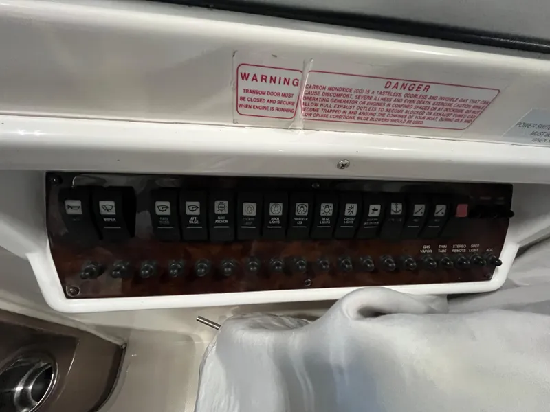 Slide: The Image of Control panel of a 2006 Regal 3360 Window Express boat with warning labels. - 14
