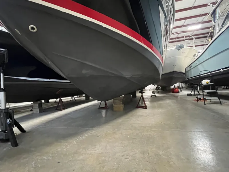 Slide: The Image of 2006 Regal 3360 Window Express boat in storage, elevated on stands indoors. - 17