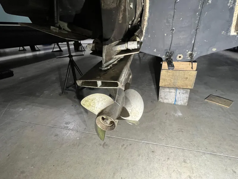 Slide: The Image of 2006 Regal 3360 Window Express boat propeller and stern drive in a workshop. - 19