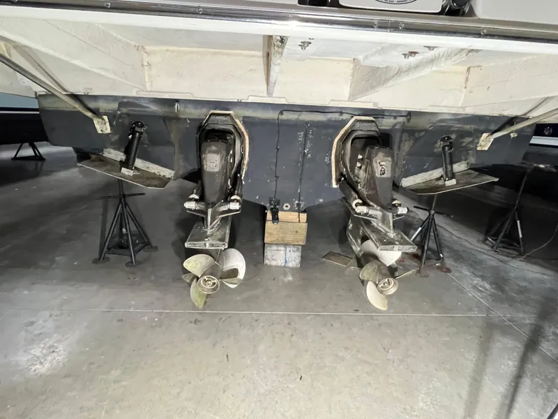 Slide: The Image of 2006 Regal 3360 Window Express boat with dual propellers in a storage facility. - 20