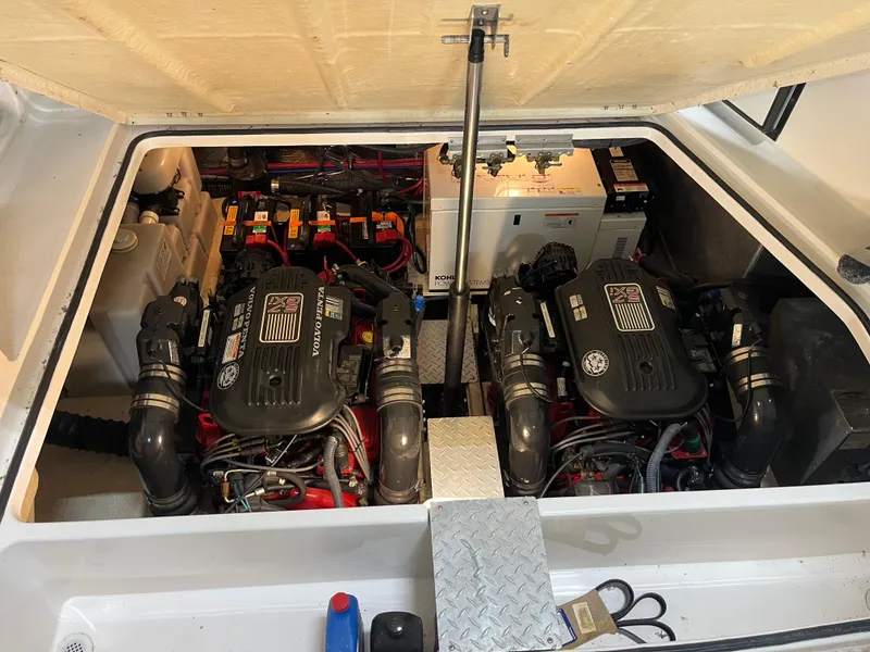 Slide: The Image of Engine compartment of a 2006 Regal 3360 Window Express boat, featuring dual engines. - 23