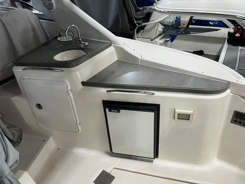 Slide: The Image of 2006 Regal 3360 Window Express boat interior with sink and mini fridge. - 29