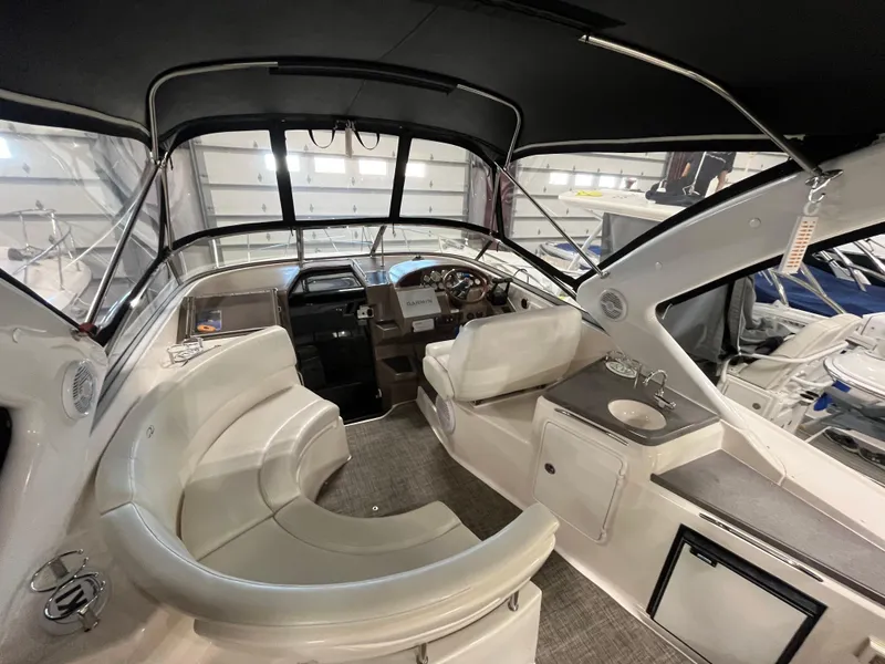 Slide: The Image of 2006 Regal 3360 Window Express boat interior with seating, helm, and kitchenette. - 31