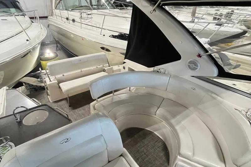 Slide: The Image of 2006 Regal 3360 Window Express yacht interior with circular seating and kitchenette. - 32