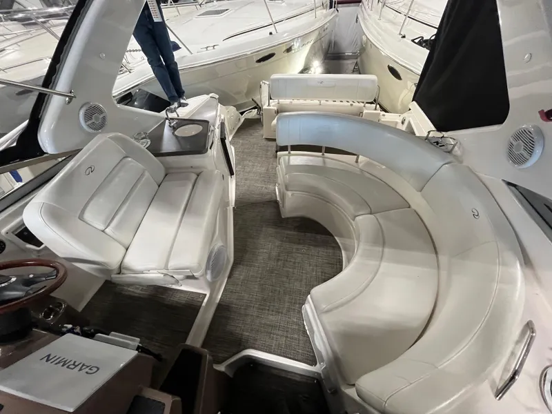 Slide: The Image of 2006 Regal 3360 Window Express boat interior with white seating and Garmin equipment. - 4