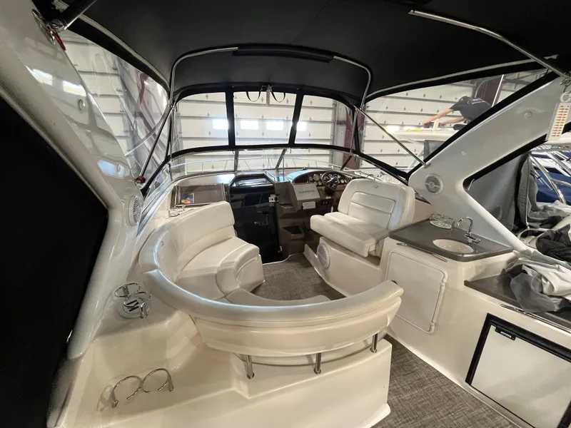 Slide: The Image of 2006 Regal 3360 Window Express boat interior with seating and helm. - 5